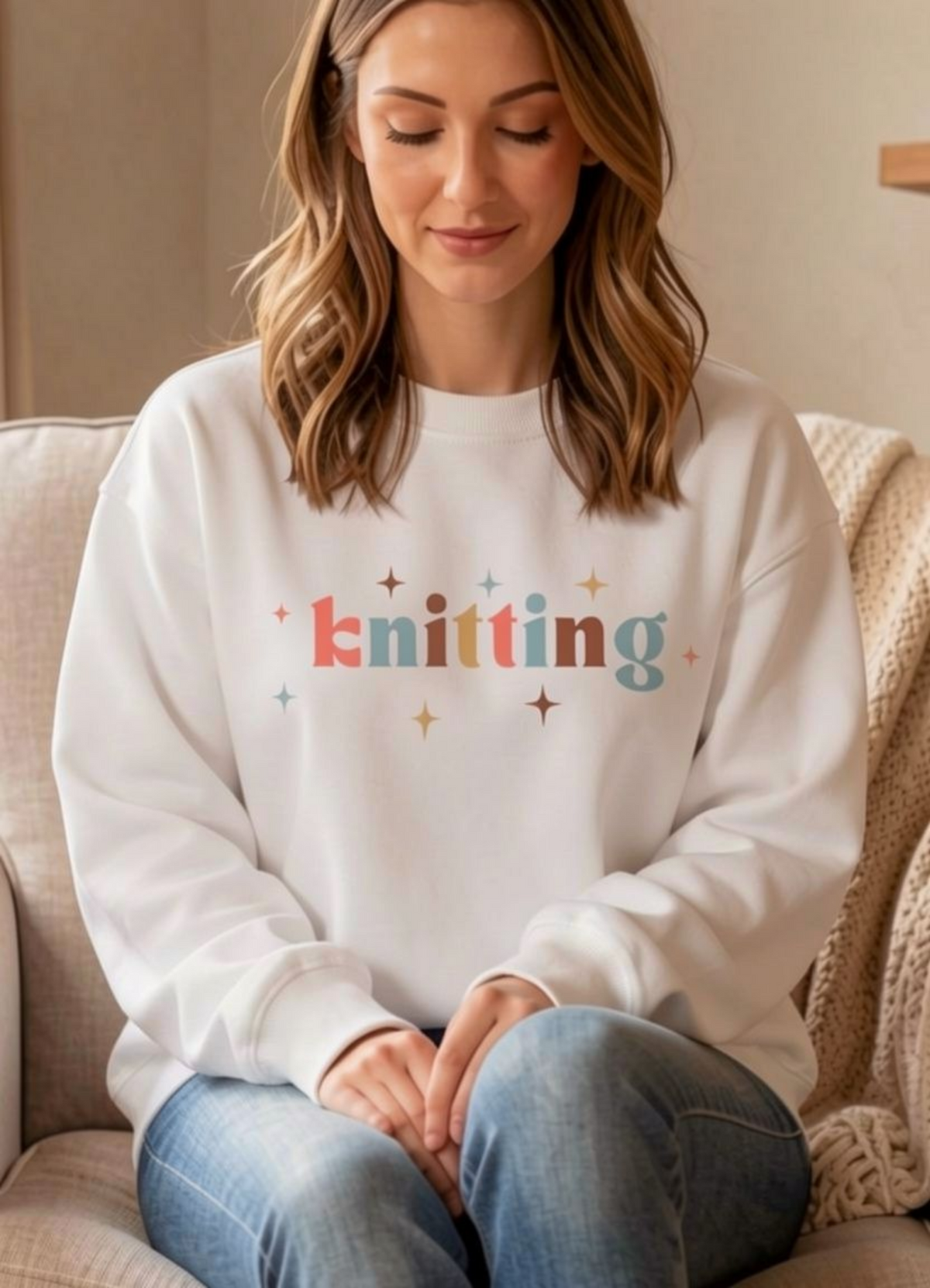 woman wearing white sweatshirt with knitting written across front