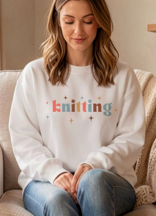 woman wearing white sweatshirt with knitting written across front