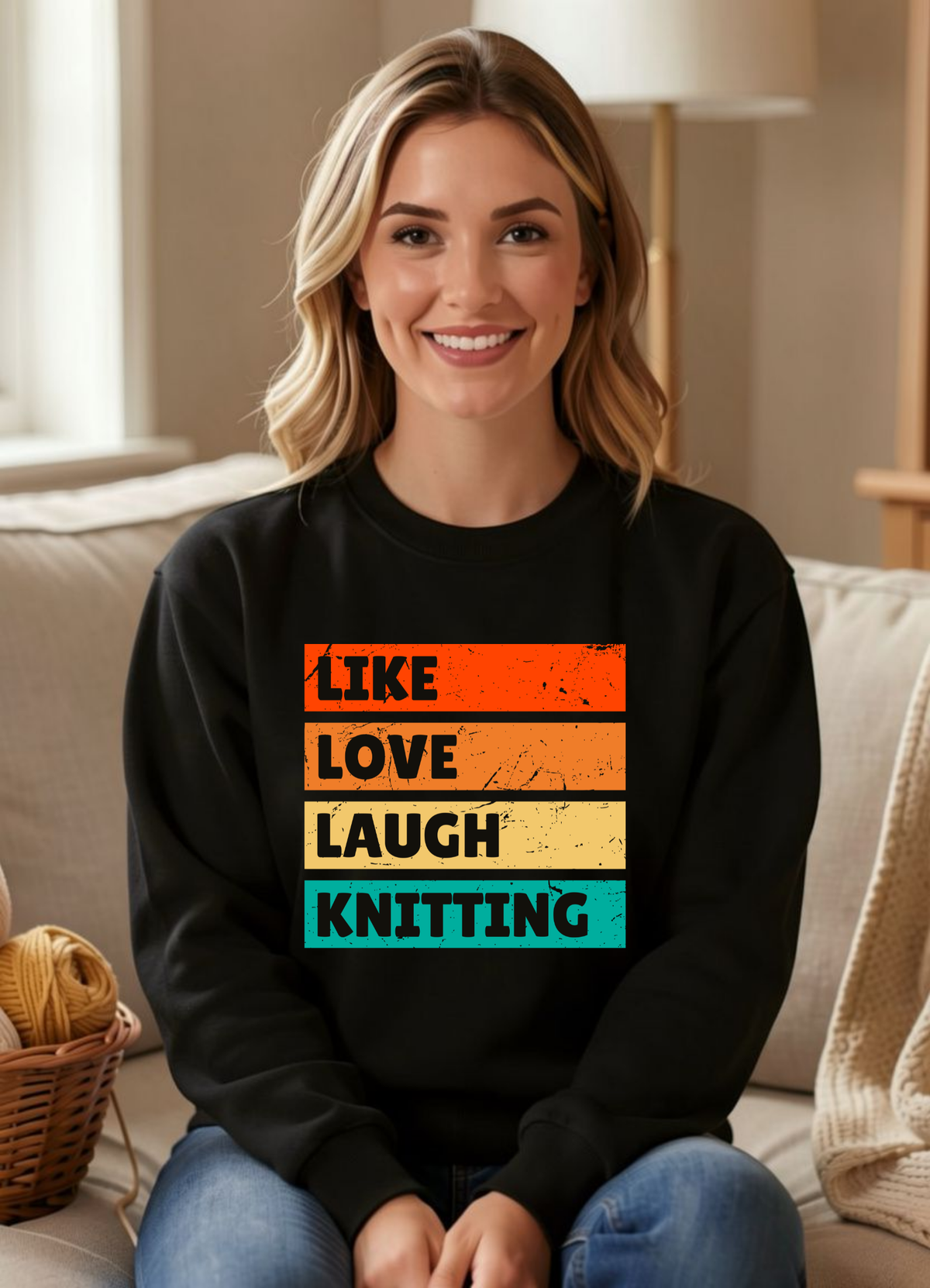 a smiling woman seated in a black sweatshirt that reads like love laugh knitting