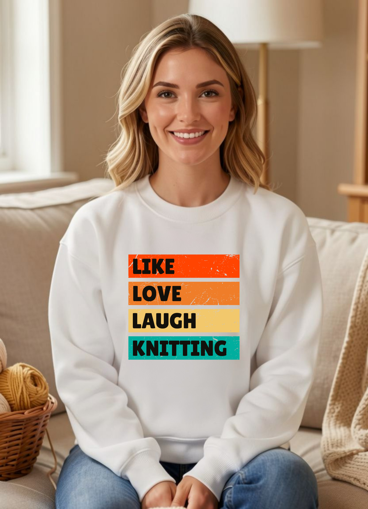a smiling woman seated in a white sweatshirt that reads like love laugh knitting