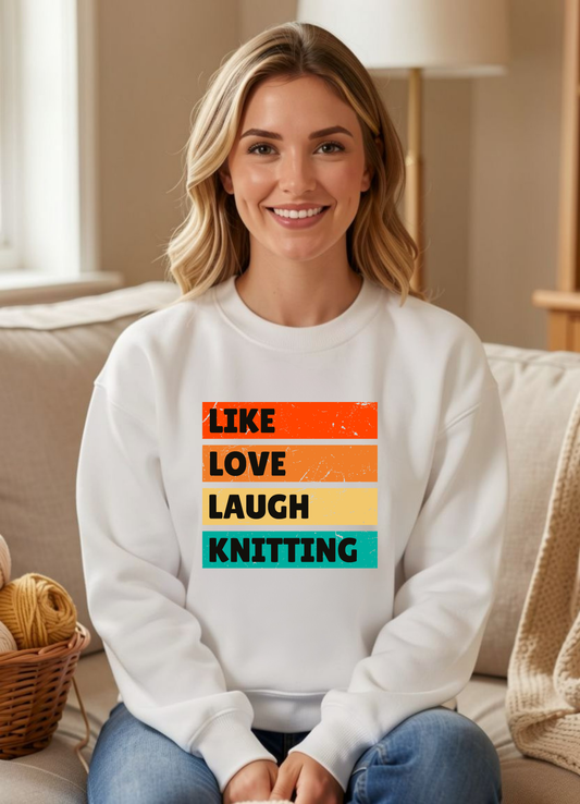 a smiling woman seated in a white sweatshirt that reads like love laugh knitting
