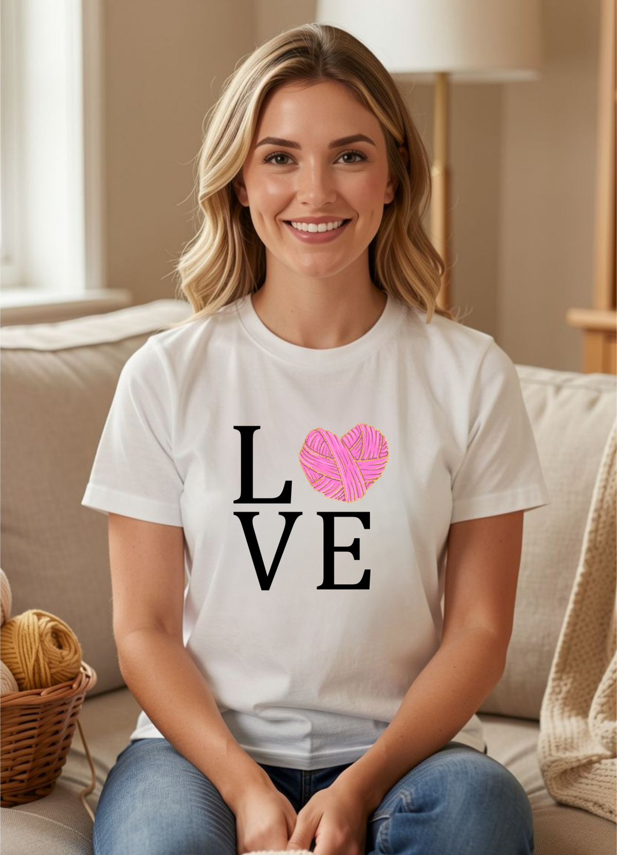 woman wearing white tshirt with design reading love with a yarn heart for the o